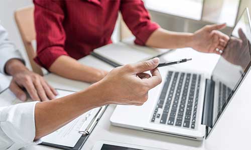 Man and woman looking at a laptop screen