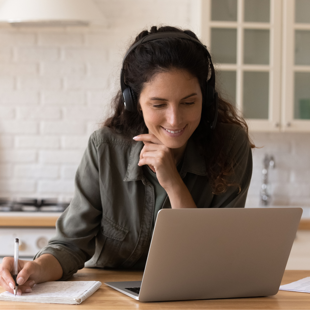 Person making notes during webinar